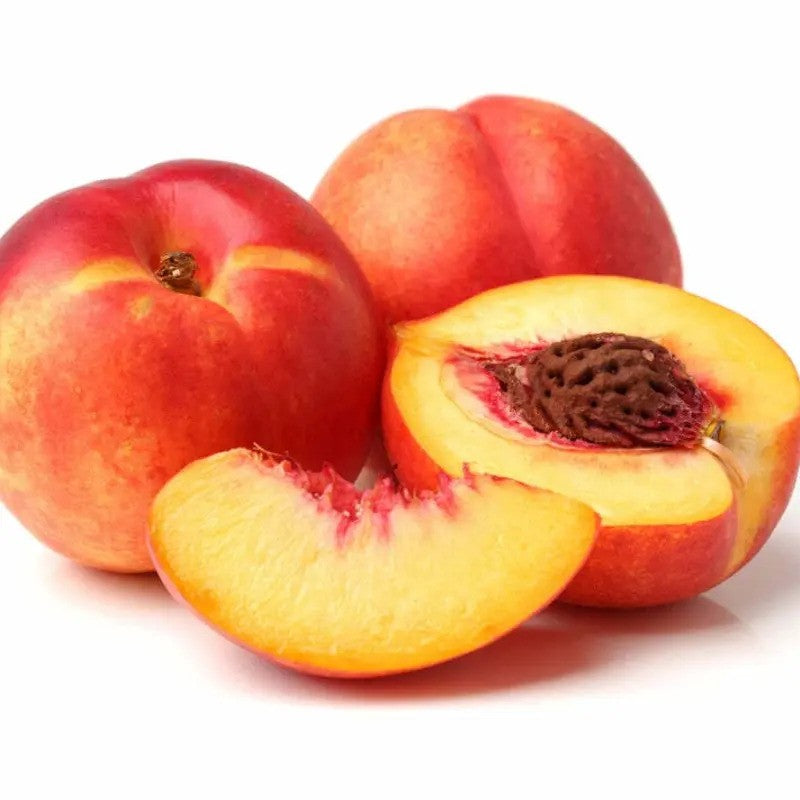 Fresh organic yellow nectarine cut open showing juicy flesh and seed inside