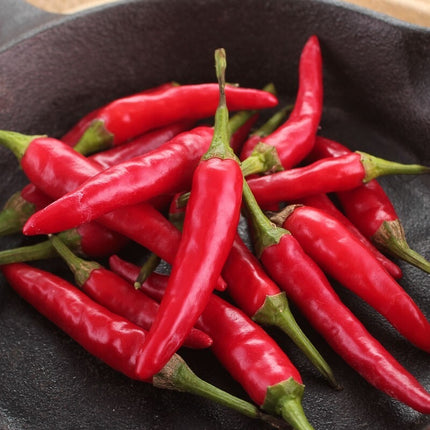Red chili peppers on a dark surface