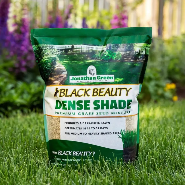 Jonathan Green Black Beauty Dense Shade premium grass seed mix bag on lush lawn. Seed World