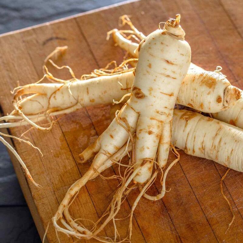 Fresh Korean ginseng roots on wood board