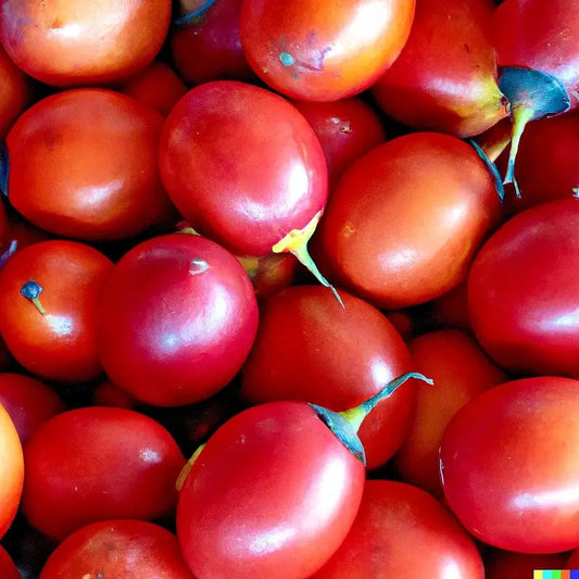 Close-up of a pile of red tomatoes with green stems.