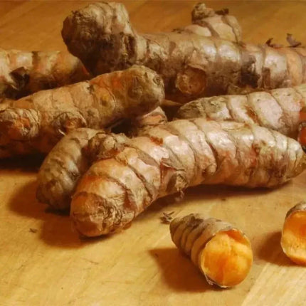Turmeric roots on a wooden surface