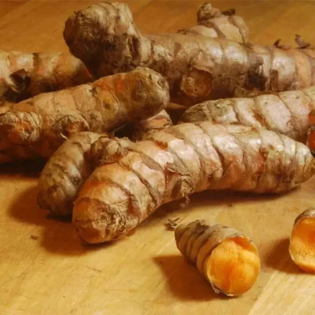 Turmeric roots on a wooden surface