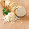 Illustrative mature horseradish root with grated horseradish; supplied pack is 1 oz of live root pieces, not the whole root shown.