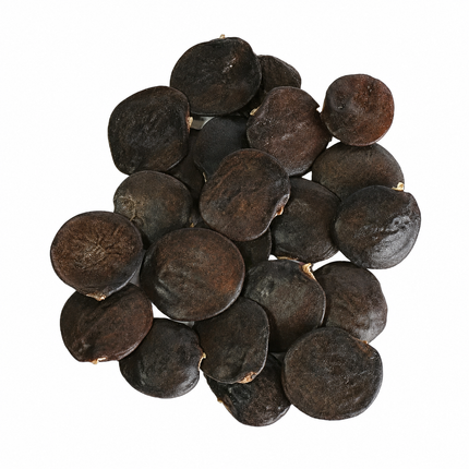A pile of dark brown, oval-shaped dried seeds or capsules, photographed from directly above on a plain white background.